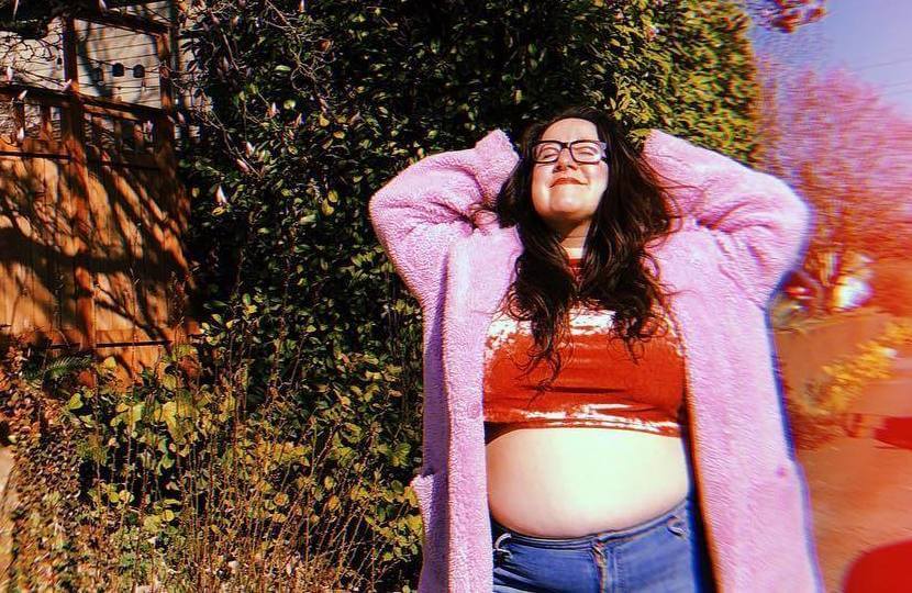 vanessa friedman wearing a plush pink jacket crop top and jeans