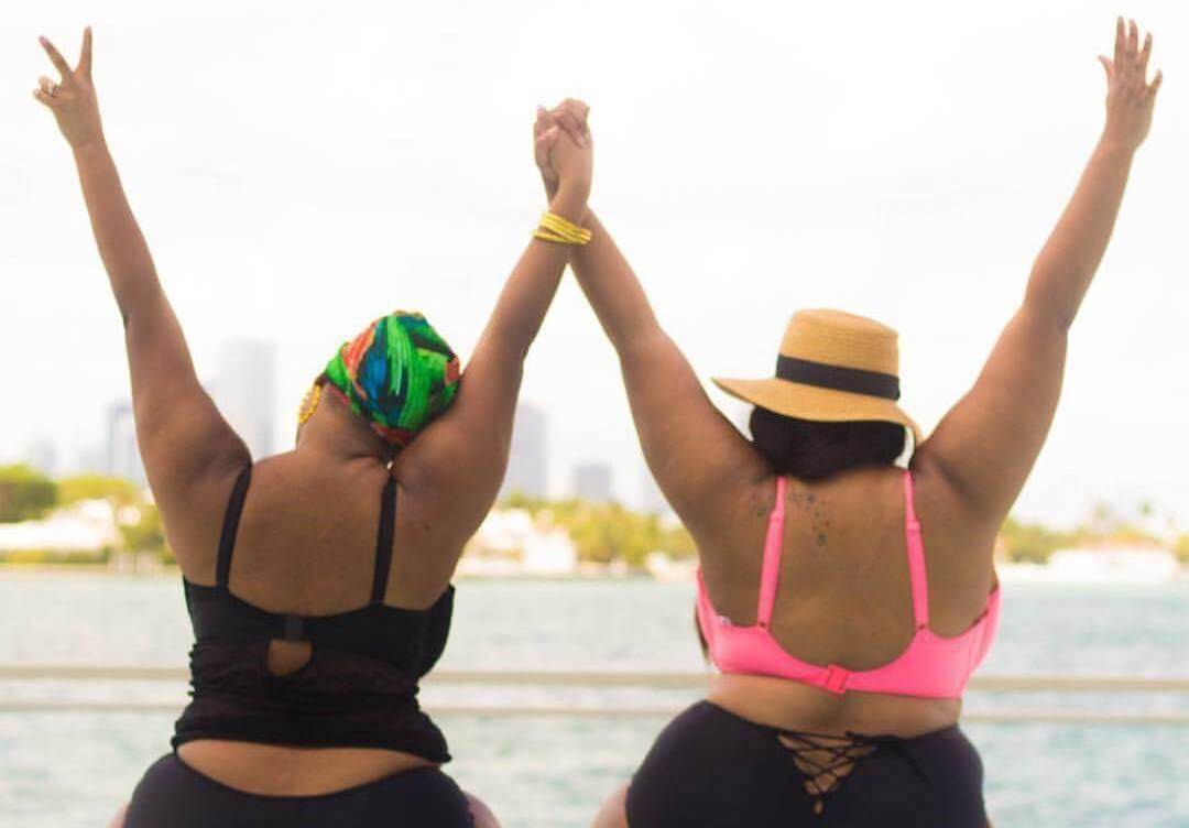plus size pool party two plus size women holding hands in bikinis