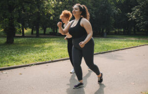 Plus size woman exercising by walking.