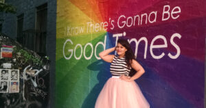 Plus size clothing startup Dia & Co's founder Nadia Boujarwah wearing a plus size fit and flare dress.